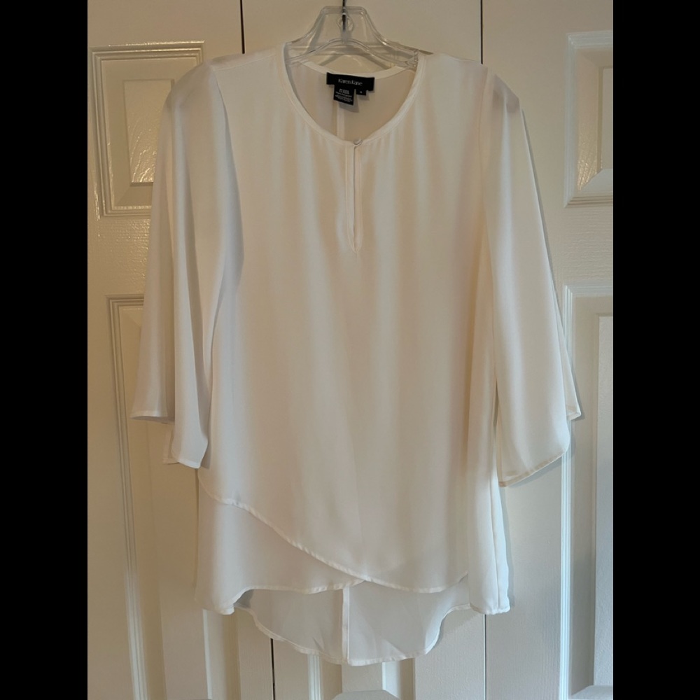Karen Kane off white blouse with beautiful flow sleeves. Slight hi low hem.